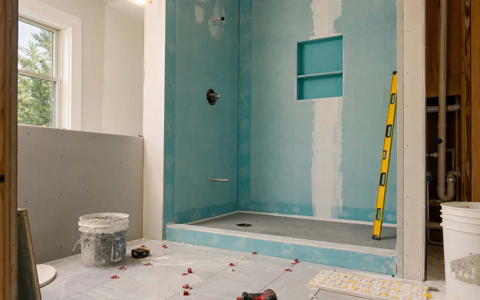 Custom shower tile and bathroom fixture details in a completed remodel