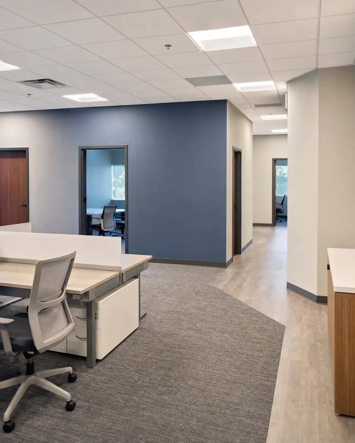 Finished office space with freshly painted low-sheen walls and a clean accent wall