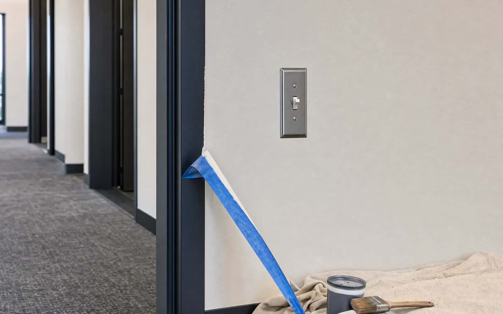 Final commercial repaint punch-list stage with crisp paint lines and clean switch plates