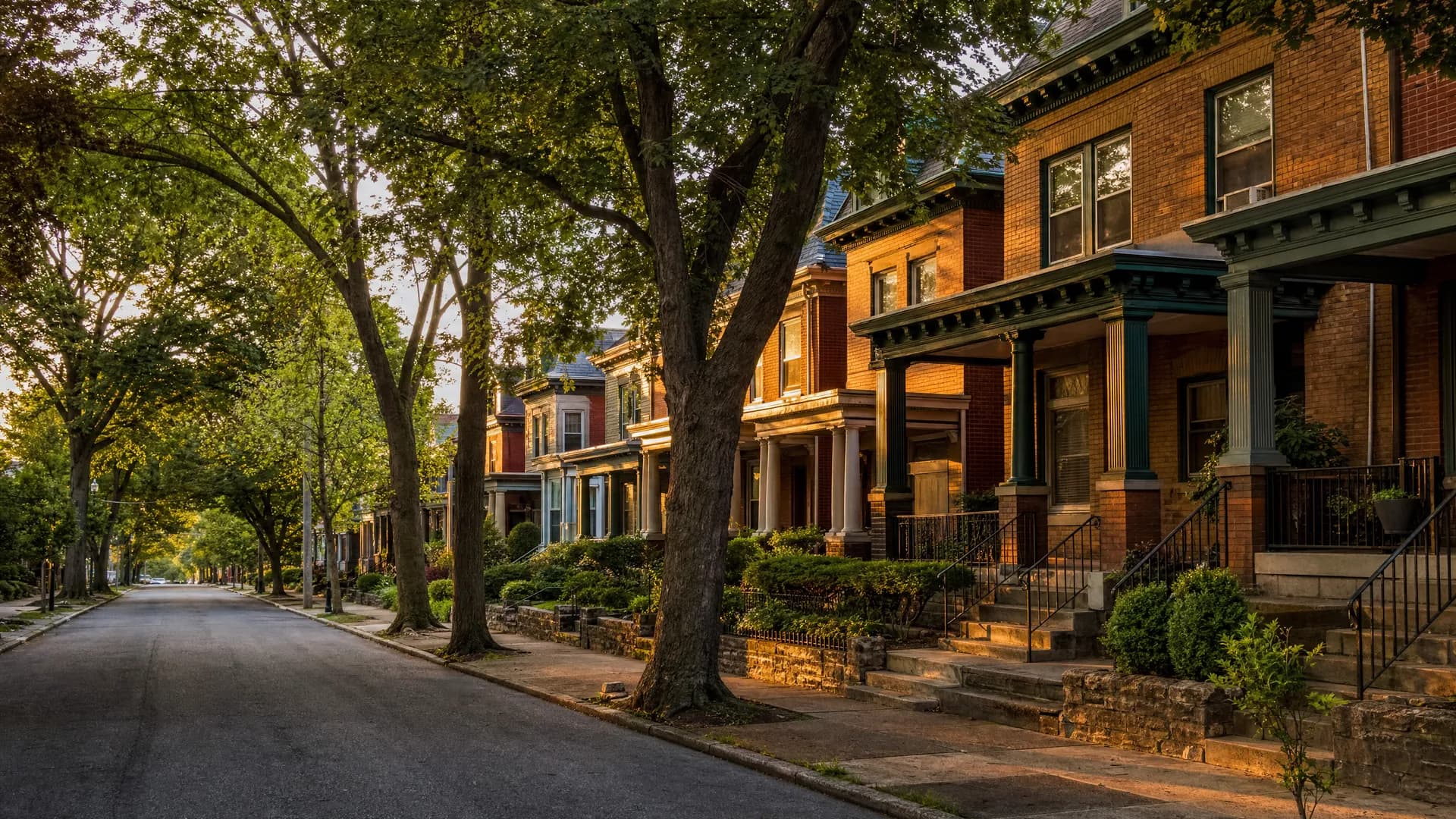 Tree-lined street of brick twin homes and rowhomes in Allentown, PA, served by Conrad General Contracting.