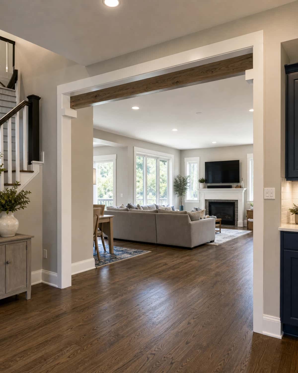 Interior expansion connecting existing and new living space with clean trim, flooring, and natural light