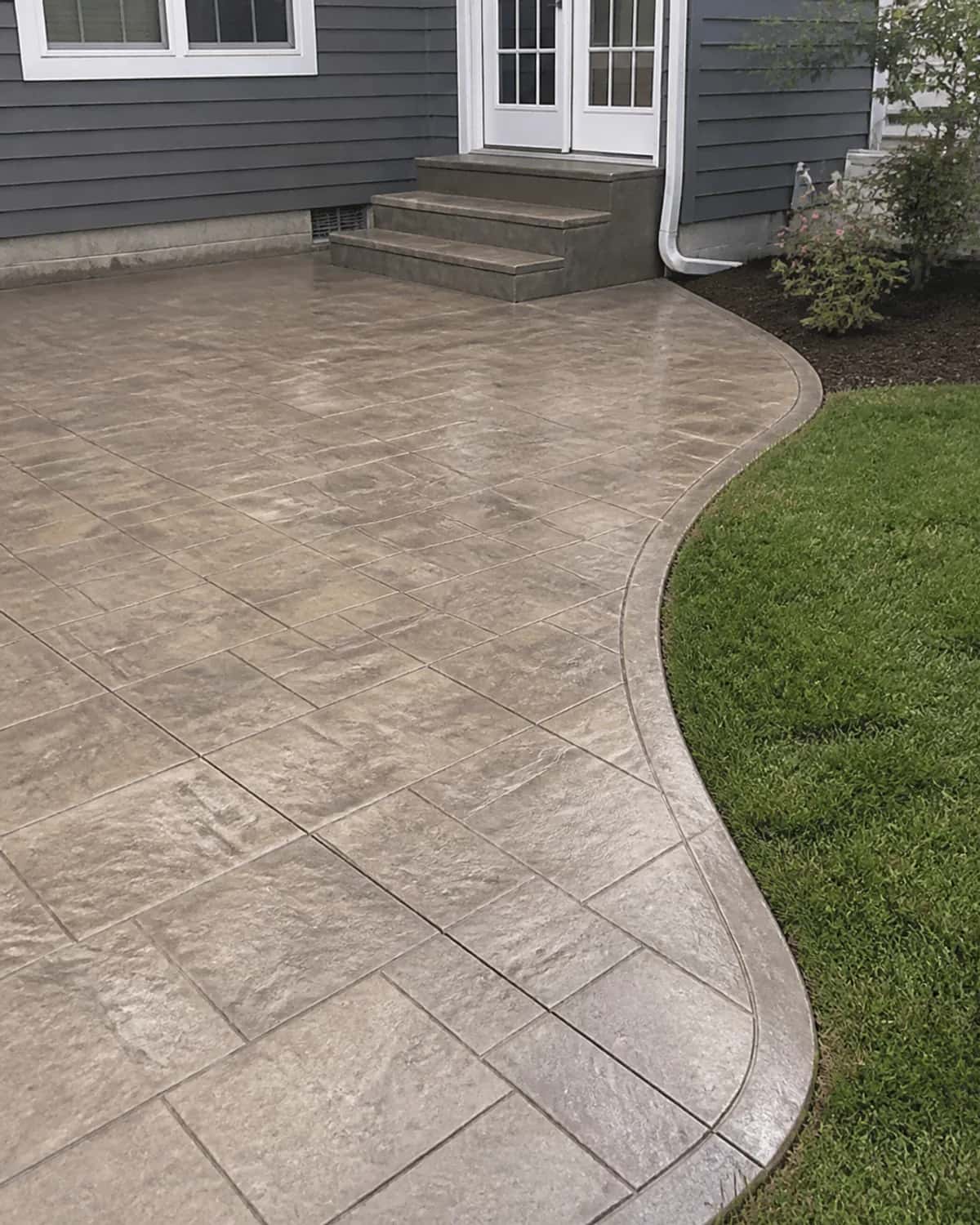 Sealed decorative concrete finish with practical residential transitions, clean edges, and durable surface detail
