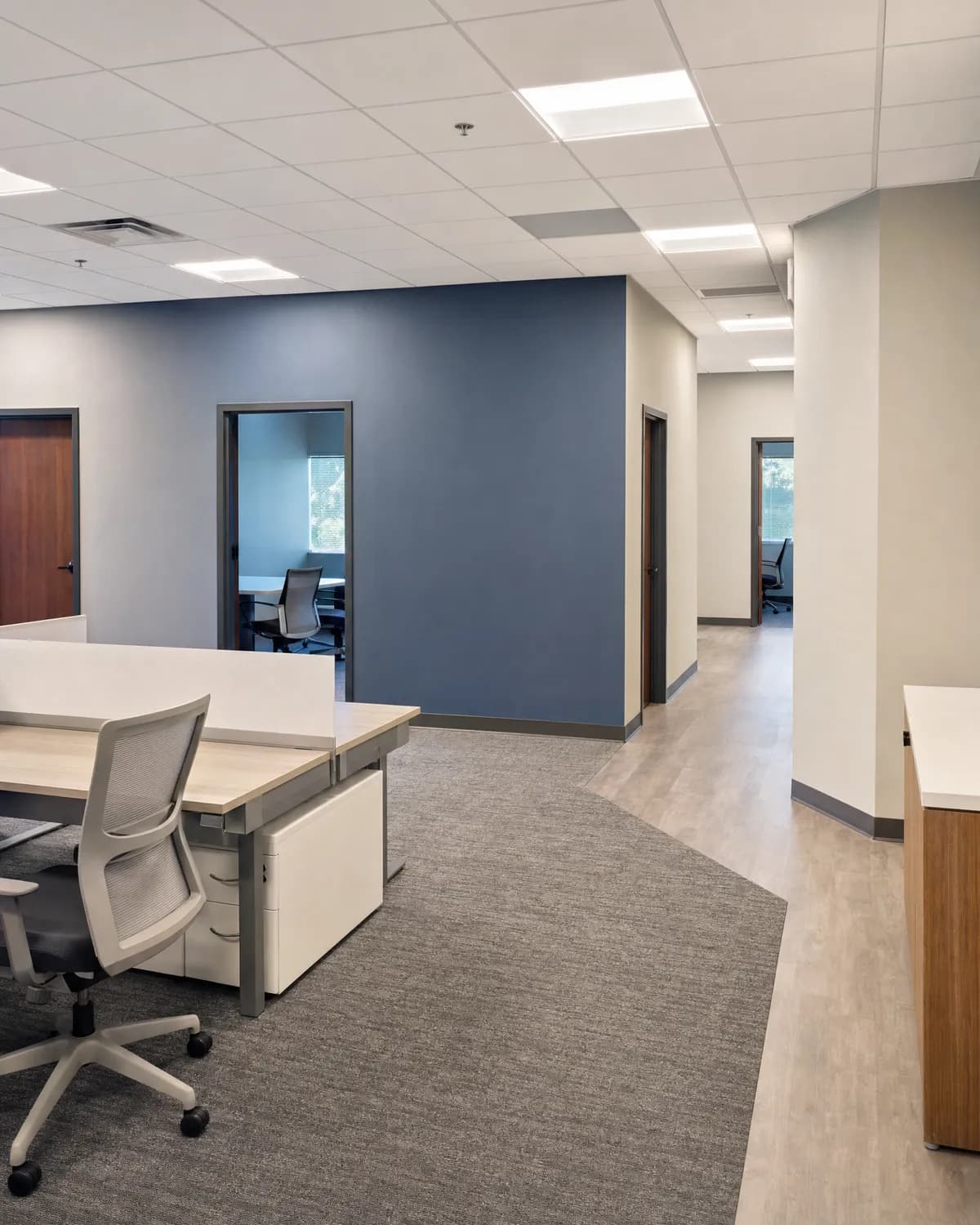 Finished office space with freshly painted low-sheen walls and a clean accent wall