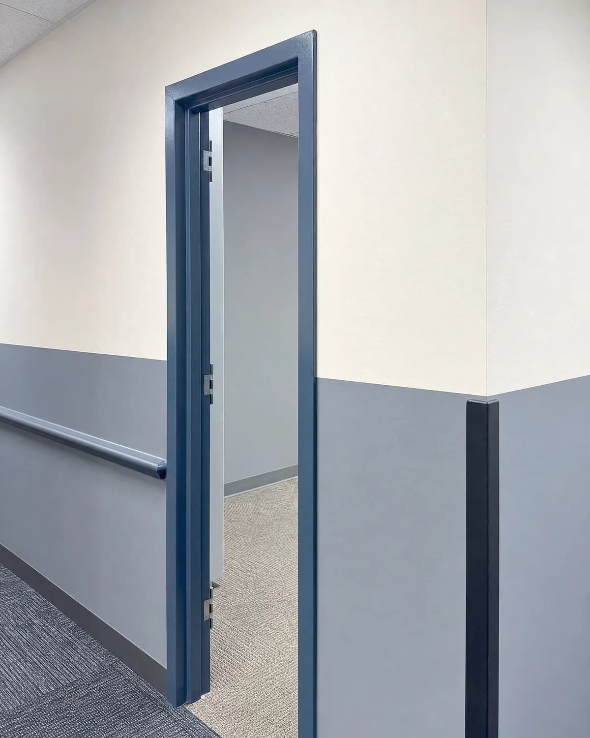 Tenant suite repaint detail with crisp two-tone walls and a satin-enamel door frame