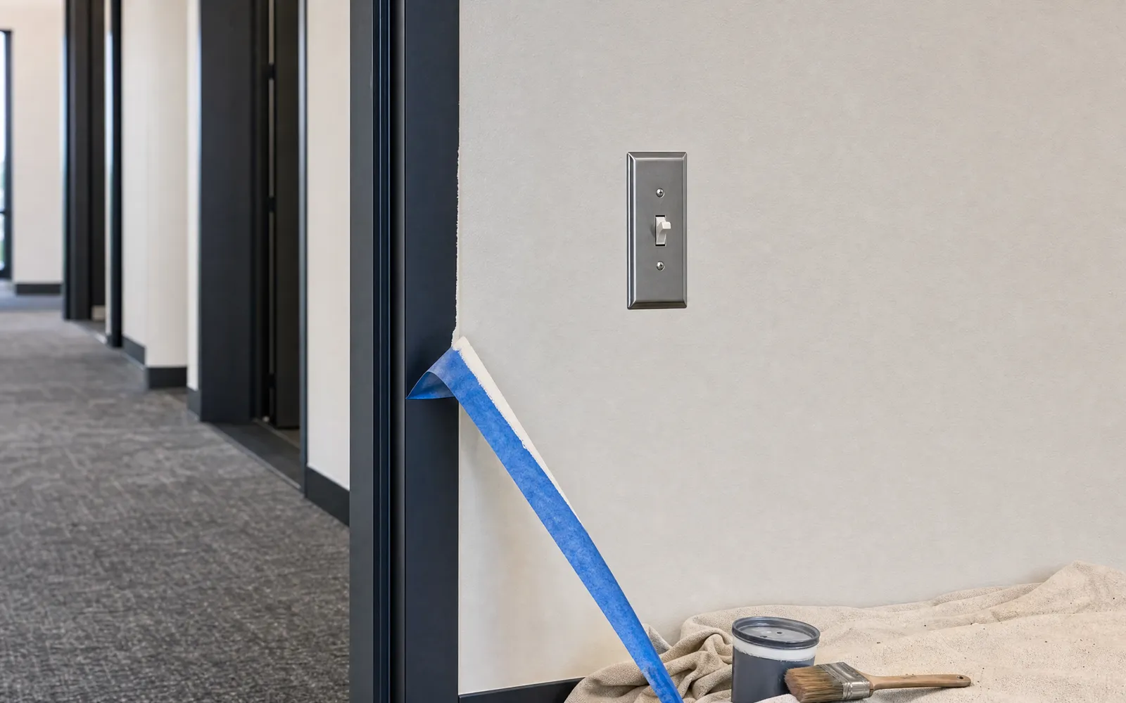 Final commercial repaint punch-list stage with crisp paint lines and clean switch plates